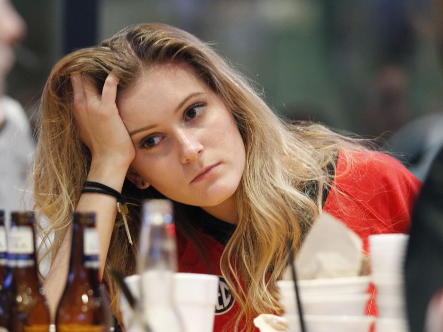 Georgia fans Anna Wilson reacts to Georgia's loss while watching the College Football Playoff national championship football game against Alabama in Athens, Ga., Monday, Jan. 8, 2018. Alabama won, 26-23. (AP Photo/Tami Chappell)