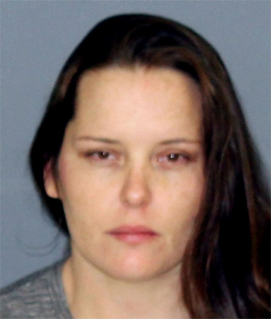 This photo provided by the Hunt County Detention Center in Greenville, Texas, shows Stephanie Leanne Flynn, the mother of a weeks-old child, who was arrested after the infant's body was found Monday, Jan. 8, 2018, at a North Texas gas station. Investigators say the baby may have died at the mother's home and the corpse was moved. Hunt County jail records show Stephanie Leanne Flynn and her sister Shawn Elise Flynn, both of Greenville, were both arrested on evidence tampering charges. Bond was $50,000 apiece. (Hunt County Detention Center via AP)