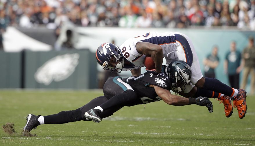 FILE - In this Nov. 5, 2017, file photo, Denver Broncos' Demaryius Thomas (88) is tackled by Philadelphia Eagles' Patrick Robinson (21) during the first half of an NFL football game in Philadelphia. Jim Schwartz's defense did what no other unit could do in 2016: Stop the high-flying Falcons. They have to do it again with an NFC championship berth at stake. (AP Photo/Matt Rourke, File)