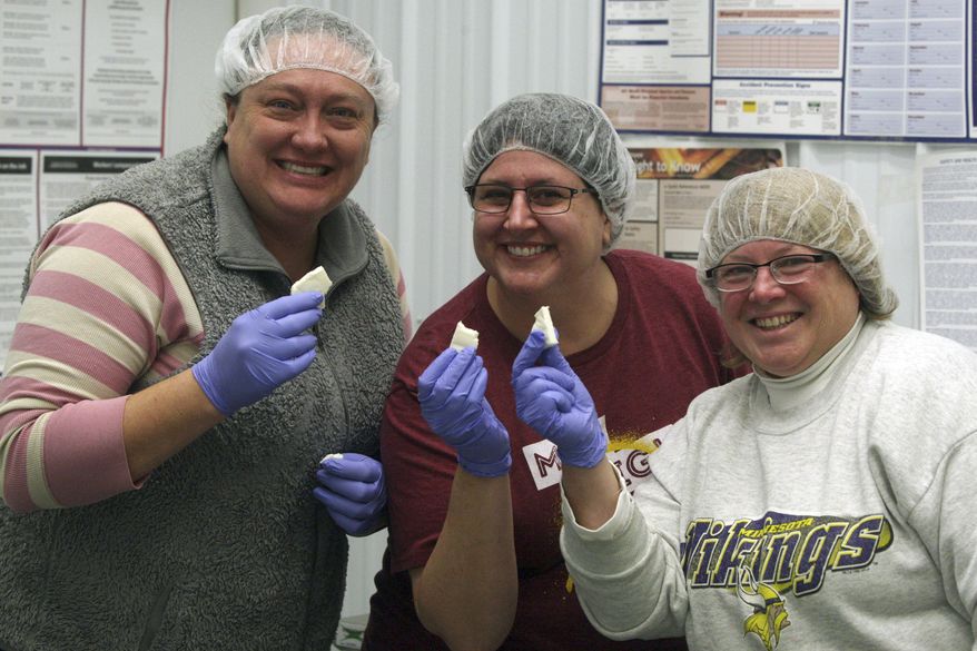 In this Dec. 19, 2017, photo, Jackie Ohmann, from left, Deeann Lufkin and Kathy Hupf pose for a photo in Cannon Falls, Minn. CannonBelles started with Ohmann and Deeann, making 20-minute mozzarella at home. After recruiting Hupf to join, the three women are making local, homemade cheeses that are competing in top competition. (Matthew Lambert/The Rochester Post-Bulletin via AP)