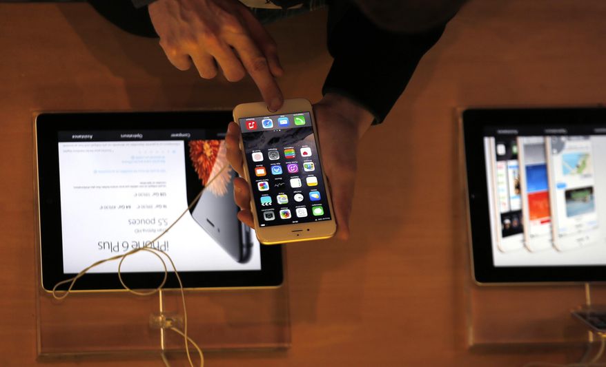 In this Sept. 19, 2014, file photo, a customer checks the iPhone 6, in Paris. A French prosecutor office said Tuesday, Jan.9, 2018, that an investigation into Apple over alleged planned obsolescence of some of its smartphones has been opened. It follows a legal complaint filed in December by pro-consumer group Halte a l'obsolescence programmee (Stop Planned Obsolescence). Under a 2015 law, it is banned to intentionally shorten lifespan of a product in order to incite customers replace it. (AP Photo/Christophe Ena, File)