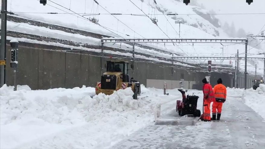 In this image taken from video provided by Lars Mlekusch a bulldozer clears snow on a road in Zermatt Switzerland Tuesday Jan. 9, 2018. Swiss authorities near the famed Matterhorn peak have closed ski slopes, hiking trails, cable cars, roads and train service into the nearby town of Zermatt amid a heightened risk of avalanches, stranding some 13,000 tourists in the town. (Lars Mlekusch via AP)