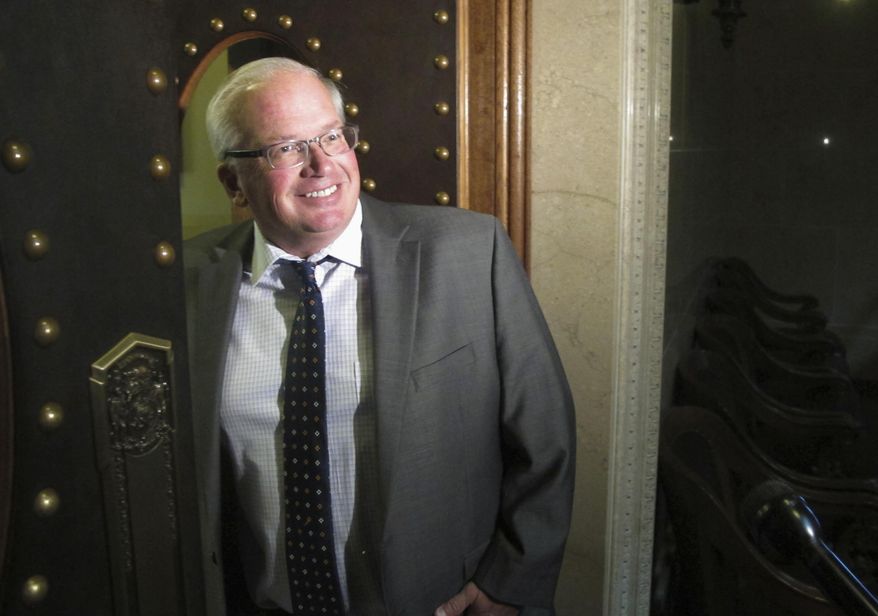 FILE - In this June 28, 2017 file photo, Wisconsin Republican Senate Majority Leader Scott Fitzgerald walks into his office at the State Capitol in Madison. Fitzgerald is rejecting calls to hold a public hearing on the confirmation of Ethics and Elections commission leaders. Fitzgerald's spokesman Dan Romportl said Tuesday, Jan. 9, 2018, that the plan remains for the Senate to vote Jan. 23 on rejecting the confirmation of Michael Haas as Elections Commission administrator and Brian Bell as Ethics Commission head. (AP Photo/Scott Bauer, File)