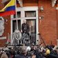 WikiLeaks founder Julian Assange looks out on the balcony of the Ecuadorian embassy prior to speaking, in London, Friday May 19, 2017. Assange has won his battle against extradition to Sweden, which wanted to question him about a rape allegation. He has spent nearly five years inside the Embassy of Ecuador in London to avoid being sent to Sweden, which announced Friday that the investigation has been discontinued. (AP Photo/Matt Dunham)