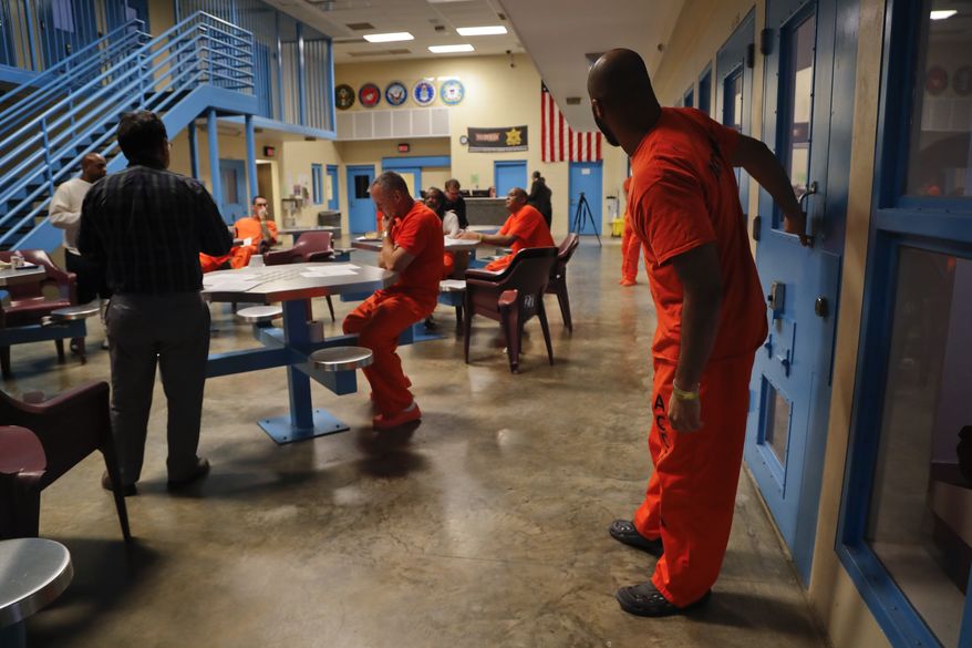 Inmates inside the veteran&#39;s pod take a break during a session with Soldier On Chaplain Quentin Chin, left, at the Albany County Correctional Facility, Monday, Nov. 27, 2017, in Albany, N.Y. Albany County&#39;s jail devotes one of its housing units for veterans, an increasingly common feature of state and county lockups as the criminal justice system focuses more on helping them reintegrate into society. (AP Photo/Julie Jacobson)