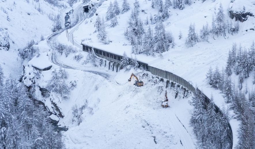 A digger at work where an avalanche has blocked the road between Taesch and Zermatt, Wednesday Jan. 10, 2018. Swiss authorities have closed ski slopes, hiking trails, cable cars, roads into the town of Zermatt amid a heightened risk of avalanches, stranding some 13,000 tourists in the town. A train packed with tourists has begun the descent from a snowbound town near Switzerland&#x27;s Matterhorn as railway service resumed following a nearly two-day suspension due to avalanche risks.(Dominic Steinmann/Keystone via AP)