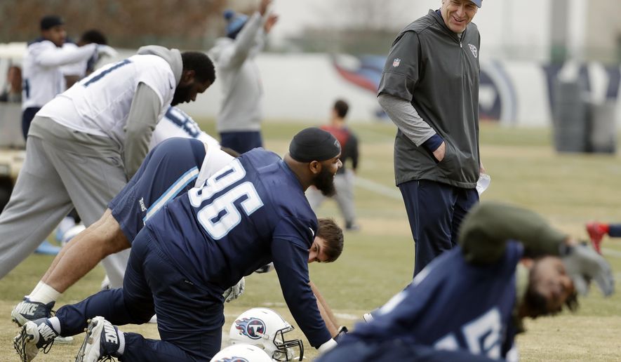 Tennessee Titans head coach Mike Mularkey talks with defensive tackle Sylvester Williams (96) during an NFL football practice Wednesday, Jan. 10, 2018, in Nashville, Tenn. The Titans are scheduled to play the New England Patriots in an AFC divisional round playoff game Saturday. (AP Photo/Mark Humphrey)