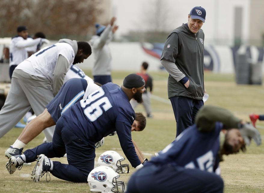 Tennessee Titans head coach Mike Mularkey talks with defensive tackle Sylvester Williams (96) during an NFL football practice Wednesday, Jan. 10, 2018, in Nashville, Tenn. The Titans are scheduled to play the New England Patriots in an AFC divisional round playoff game Saturday. (AP Photo/Mark Humphrey)