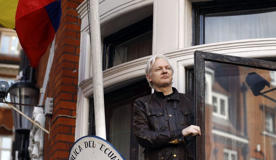 In this Friday May 19, 2017, file photo, WikiLeaks founder Julian Assange greets supporters outside the Ecuadorian embassy in London. (AP Photo/Frank Augstein, File) 