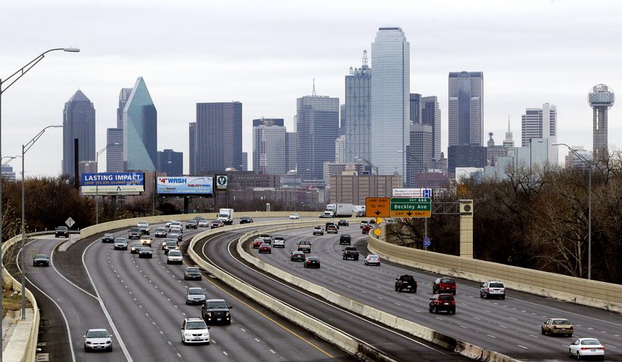 FILE - This Friday, Jan. 14, 2011, file photo shows highway IH-30 traffic with the Dallas skyline in the background. Dallas is one of the many cities vying to land Amazon's second headquarters. While Texas cities vying to land the new headquarters have been vocal about why they think they should win, they've resisted releasing copies of their proposals. (AP Photo/Tony Gutierrez, File)