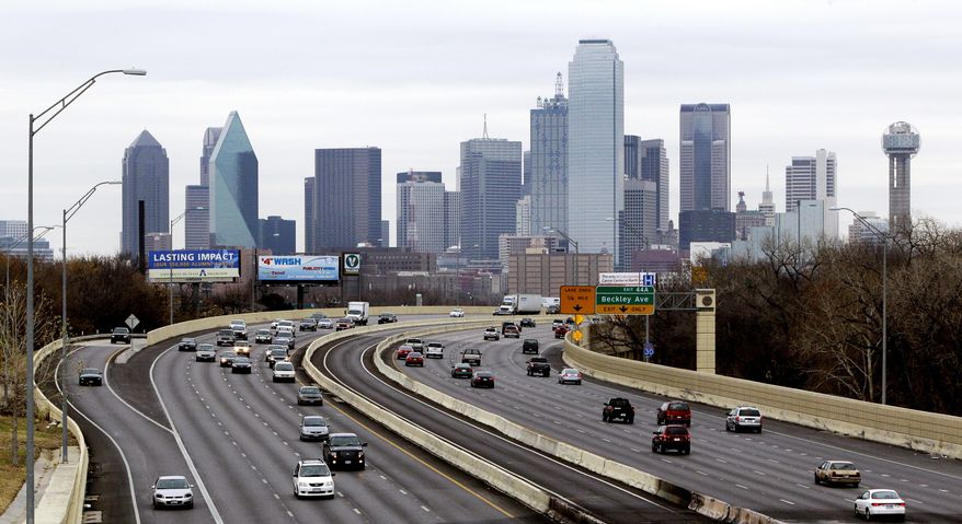 FILE - This Friday, Jan. 14, 2011, file photo shows highway IH-30 traffic with the Dallas skyline in the background. Dallas is one of the many cities vying to land Amazon's second headquarters. While Texas cities vying to land the new headquarters have been vocal about why they think they should win, they've resisted releasing copies of their proposals. (AP Photo/Tony Gutierrez, File)