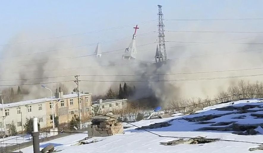 In this image taken from video shot Tuesday, Jan. 9, 2018, by China Aid and provided to the Associated Press, clouds of debris billow during the demolition of the Golden Lampstand Church in Linfen in northern China's Shanxi province. Witnesses and overseas activists say paramilitary troops known as the People's Armed Police used excavators and dynamite on Tuesday to destroy the Golden Lampstand Church, a Christian mega-church that clashed with the government. (China Aid via AP)