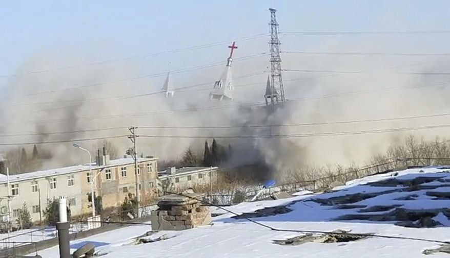 In this image taken from video shot Tuesday, Jan. 9, 2018, by China Aid and provided to the Associated Press, clouds of debris billow during the demolition of the Golden Lampstand Church in Linfen in northern China's Shanxi province. Witnesses and overseas activists say paramilitary troops known as the People's Armed Police used excavators and dynamite on Tuesday to destroy the Golden Lampstand Church, a Christian mega-church that clashed with the government. (China Aid via AP)