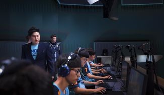 In this Dec. 7, 2017 photo provided by Blizzard Entertainment several members of the London Spitfire esports team compete in a preseason match in the Overwatch League at Blizzard Arena in Burbank, Calif. The new Overwatch League is a well-funded attempt to combine cutting-edge esports competition with a traditional sports league structure. (Robert Paul/Blizzard Entertainment via AP)