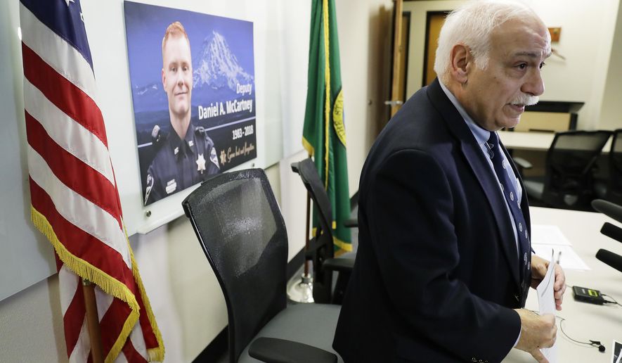 Pierce County Sheriff Paul Pastor stands up after speaking Wednesday, Jan. 10, 2018, during a news conference to update reporters on the status of the investigation into the fatal shooting of Deputy Daniel McCartney earlier in the week. (AP Photo/Ted S. Warren)