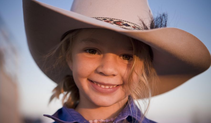 This photo taken in 2009 and provided by Akubra Hats, shows Amy "Dolly" Everett in Brunette Downs in the Northern Territory, Australia. Hundreds of people are remembering Dolly who was known as the angelic face of the Australian bushmen's hat brand and whose family says she killed herself after being targeted by cyberbullying. A memorial service for Dolly was held in the tiny Northern Territory town of Katherine on Friday, Jan. 12, 2018 near her family's cattle ranch. (Akubra Hats via AP)