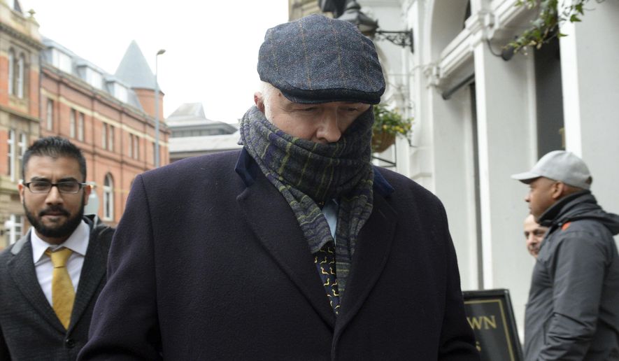 Specialist surgeon Simon Bramhall leaves Birmingham Crown Court in Birmingham, England, Friday, Jan. 12, 2018. A British surgeon who burned his initials into patients' livers during transplant operations has been fined 10,000 pounds ($13,600) and ordered to perform community service. Simon Bramhall pleaded guilty last month to two counts of assault, in a case a prosecutor called "without legal precedent in criminal law." (Joe Giddens/PA via AP)