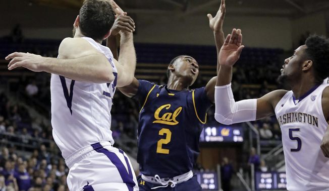 California's Juhwan Harris-Dyson (2) and Washington's Sam Timmins, left, and Jaylen Nowell eye a loose ball during the first half of an NCAA college basketball game Thursday, Jan. 11, 2018, in Seattle. (AP Photo/Elaine Thompson)