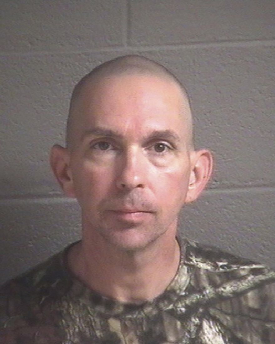 FILE- This undated file photo provided by the Buncombe County Detention Center shows Michael Christopher Estes, charged with stashing a jar filled with explosive chemicals and nails at the Asheville Regional Airport in Asheville, N.C. A news release from the U.S. Department of Justice said the 46-year-old Estes pleaded guilty Friday, Jan. 12, 2018, to unlawful possession of explosive material. According to prosecutors, Estes told law enforcement the country was getting ready to "fight a war on U.S. soil," and that terrorists were coming to the country. (Buncombe County Detention Center via AP, File)
