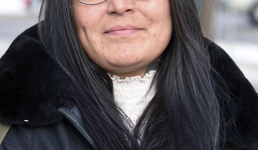 FILE - In this Dec. 8, 2017, file photo, Red Fawn Fallis, of Denver, stands outside the federal courthouse in Bismarck, N.D. Fallis, accused of shooting at law officers in October 2016 during protests in North Dakota against the Dakota Access oil pipeline, will not receive more information about an FBI informant she alleges seduced her and owned the gun. She is to stand trial in federal court in Fargo beginning Jan. 29, 2018. No one was injured in the shooting, (Tom Stromme /The Bismarck Tribune via AP, File)
