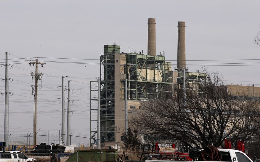 OG&E's Mustang Energy Center power plant is pictured in Oklahoma City, Wednesday, Jan. 10, 2018. Oklahoma Attorney General Mike Hunter has asked for a reduction in customer utility rates from the state's leading utility companies, after the corporate income tax rate went from 35 percent to 21 percent. (AP Photo/Sue Ogrocki)