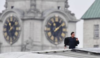 Actor Tom Cruise runs along the rooftop of Blackfriars station, during filming for the new Mission Impossible 6 film, in London, Saturday Jan. 13, 2018. (John Stillwell/PA via AP)