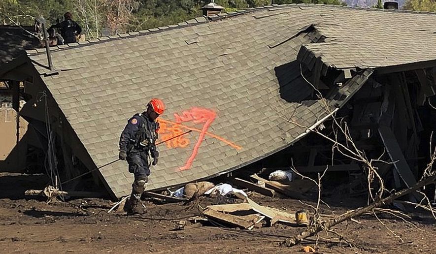This photo provided by the Santa Barbara County Fire Department shows firefighters making secondary searches on homes damaged and destroyed by deadly rain and mudflow in Montecito, Calif., Friday, Jan. 12, 2018. Dozens of homes were swept away or heavily damaged and several people were killed Tuesday, Jan. 9, as downpours sent mud and boulders roaring down hills stripped of vegetation by a the gigantic Thomas wildfire that raged in Southern California last month. (Mike Eliason/Santa Barbara County Fire Department via AP)