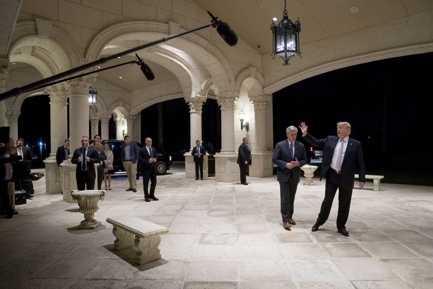 President Donald Trump, accompanied by House Majority Leader Kevin McCarthy of Calif., waves to members of the media as they arrive for a dinner at Trump International Golf Club in in West Palm Beach, Fla., Sunday, Jan. 14, 2018. (AP Photo/Andrew Harnik)