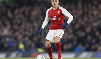 FILE - In this file photo dated Wednesday, Jan. 10, 2018, Arsenal&#x27;s Alexis Sanchez during the English League Cup semifinal first leg soccer match between Chelsea and Arsenal at Stamford Bridge stadium in London.  Chilean player Sanchez has been left out of Arsenal’s squad for the Premier League match against Bournemouth on Sunday Jan. 14, 2018, amid interest in the forward from Manchester City and Manchester United. (AP Photo/Kirsty Wigglesworth, FILE)