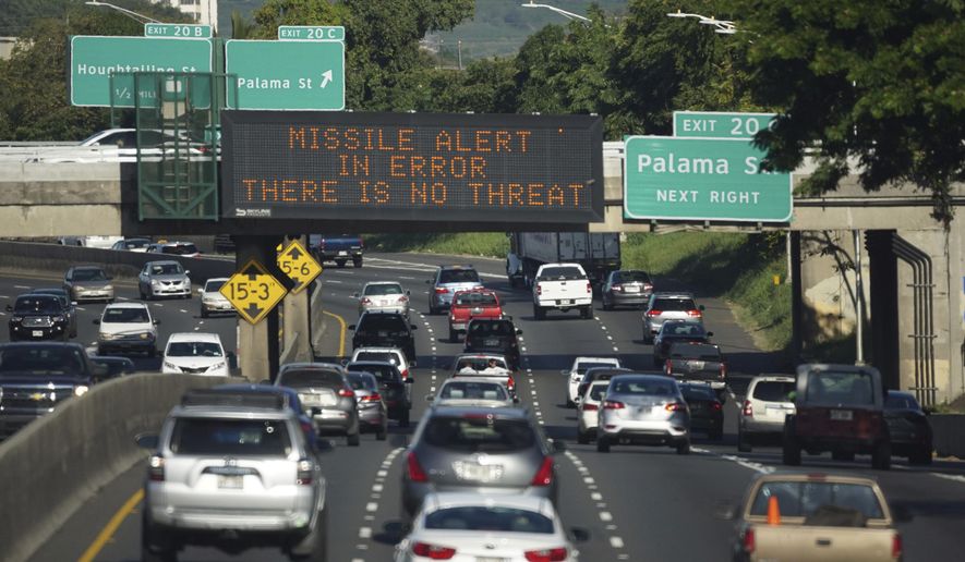 In this Saturday, Jan. 13, 2018 photo provided by Civil Beat, cars drive past a highway sign that says "MISSILE ALERT ERROR THERE IS NO THREAT" on the H-1 Freeway in Honolulu. The state emergency officials announced human error as cause for a statewide announcement of an incoming missile strike alert that was sent to mobile phones. (Anthony Quintano/Civil Beat via AP)