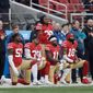 The San Francisco 49ers, who did not qualify for the NFL postseason, had only four players taking a knee during the national anthem by Week 17. Kneeling at Week 16 were (from left) Eli Harold, Eric Reid, Marquise Goodwin and Louis Murphy. (Associated Press/File)