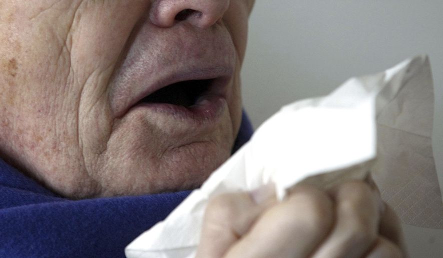 FILE - In this Jan. 14, 2005 file photo, a man sneezes holding a tissue in Berlin, Germany. According to a case study published Monday, Jan. 15, 2018, in the journal BMJ Case Reports, doctors in England say stifling a big sneeze can be hazardous for your health in rare cases, based on the very unusual experience of a man who ruptured the back of his throat when he tried to stop a sneeze. (AP Photo/Roberto Pfeil, File)