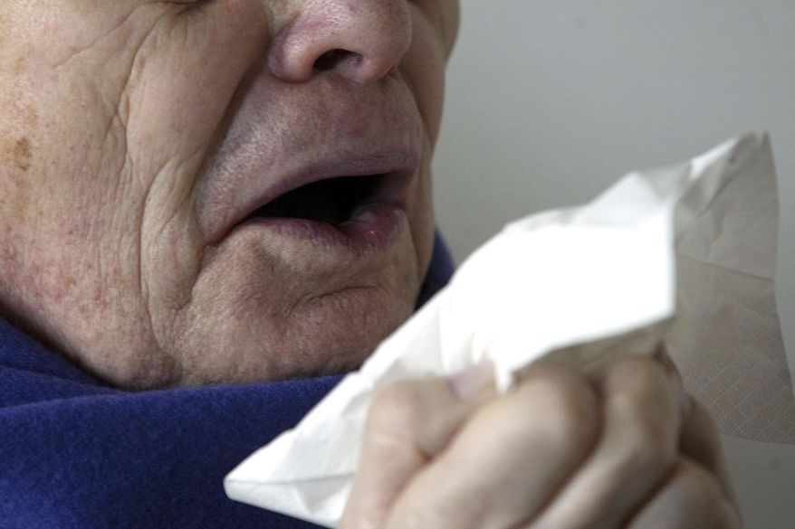 FILE - In this Jan. 14, 2005 file photo, a man sneezes holding a tissue in Berlin, Germany. According to a case study published Monday, Jan. 15, 2018, in the journal BMJ Case Reports, doctors in England say stifling a big sneeze can be hazardous for your health in rare cases, based on the very unusual experience of a man who ruptured the back of his throat when he tried to stop a sneeze. (AP Photo/Roberto Pfeil, File)