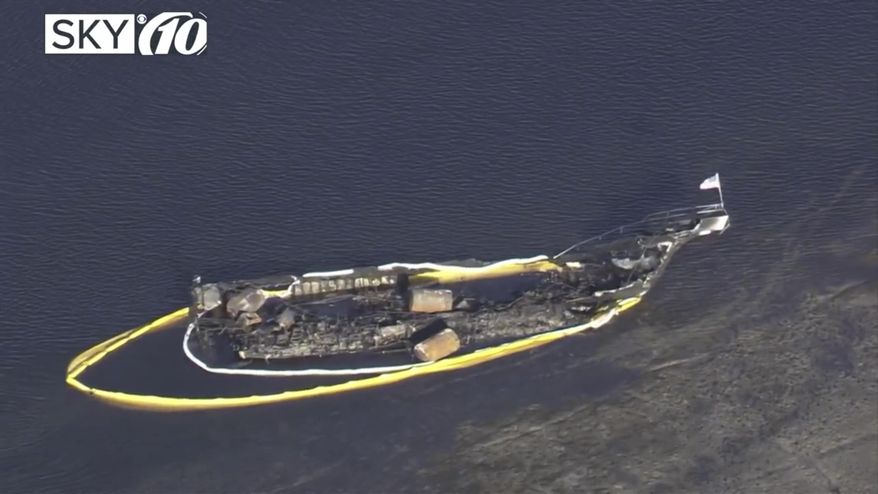 In this frame from video, the remains of a shuttle boat that caught fire off Florida's Gulf Coast floats on Monday, Jan. 15, 2018, in Port Richey, Fla. The boat ferrying patrons to a casino ship caught fire near shore Sunday afternoon, authorities said. (WTSP via AP)