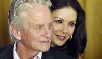 In this Dec. 9. 2016, file photo, actor Michael Douglas and his wife, actress Catherine Zeta-Jones, attend a party at the Beverly Hills Hotel in Beverly Hills, Calif. (Photo by Chris Pizzello/Invision/AP, File)