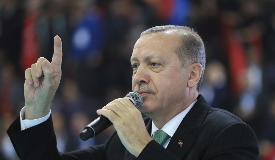 Turkey&#x27;s President Recep Tayyip Erdogan talks to supporters of his ruling Justice and Development Party (AKP), at a rally in Yozgat, eastern Turkey, Sunday, Jan. 14, 2018. Erdogan said Sunday the country will launch a military assault on a Kurdish enclave in northern Syria &amp;quot;in the coming days,&amp;quot; and urged the U.S. to support its efforts. (Pool Photo via AP)
