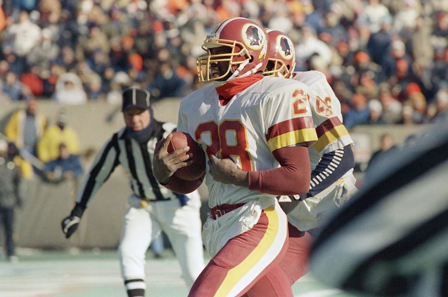Washington Redskins Darrell Green (28) scores a touchdown on a third quarter punt return against the Bears in Chicago, Sunday, Jan. 10, 1988. Washington won, 21-17. (AP Photo/Fred Jewell) **FILE**
