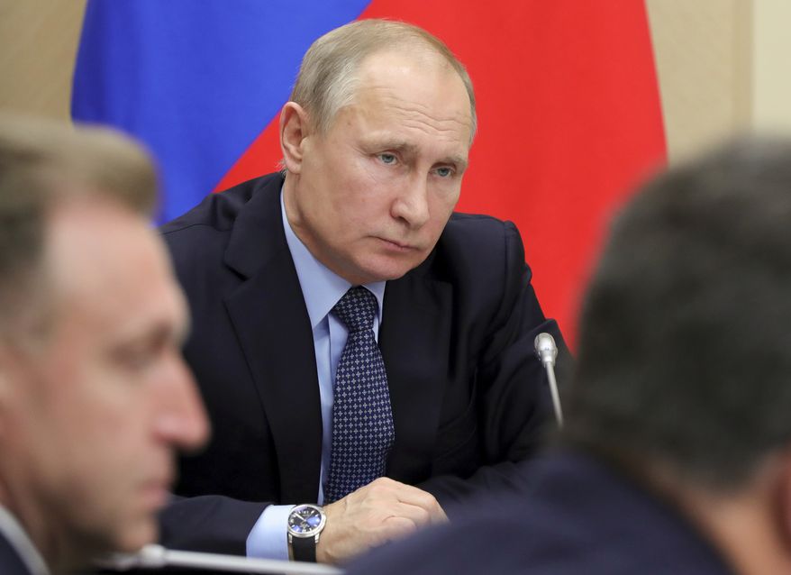 Russian President Vladimir Putin listens during a Cabinet meeting at the Novo-Ogaryovo residence outside in Moscow, Russia, Tuesday, Jan. 16, 2018. (Mikhail Klimentyev, Sputnik, Kremlin Pool Photo via AP)