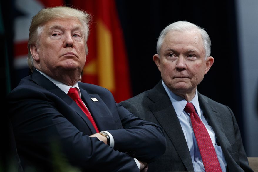 President Donald Trump (left) sits with Attorney General Jeff Sessions during the FBI National Academy graduation ceremony in Quantico, Va., on Dec. 15, 2017. (Associated Press) **FILE**