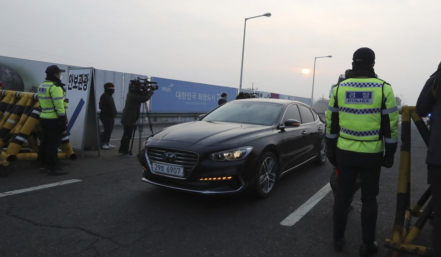 South Korean police officers stand as vehicles carrying the South Korean delegation pass at the check point at Unification Bridge, which leads to the Panmunjom in the Demilitarized Zone in Paju, South Korea, Wednesday, Jan. 17, 2018. South Korean delegation departed for Panmunjom on Wednesday morning for talks with North Korea to further discuss the North&#x27;s paricipation in the upcoming Winter Olympics. (AP Photo/Lee Jin-man)