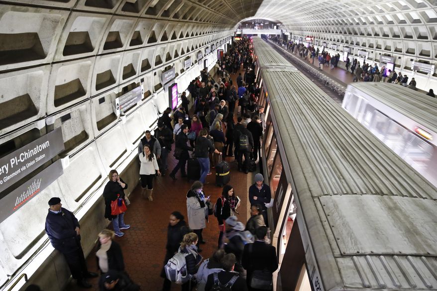 In this Jan. 11, 2018, file photo, riders wait to board as others depart a Metro train in the Gallery Place-Chinatown Metro Station in Washington. (AP Photo/Alex Brandon) ** FILE **