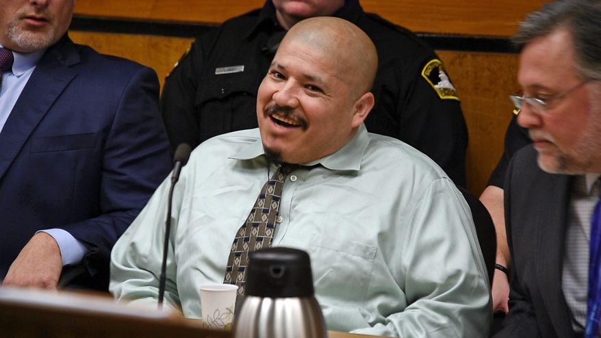 FILE - This Tuesday, Jan. 16, 2018 file photo shows Luis Bracamontes acting out in court during day one of his trial in Sacramento, Calif., Superior Court. Bracamontes, an illegal immigrant from Mexico, and his wife, Janelle Monroy are accused of a daylong crime spree in 2014 that killed Sacramento Sheriff's Deputy Danny Oliver and Placer County Sheriff's Deputy Michael Davis Jr. On Wednesday, Jan. 17, the second day of his trial, Bracamontes was removed from the courtroom after he began shouting profane threats. The judge ordered Bracamontes removed until he promises to behave himself. (Randy Pench/The Sacramento Bee via AP, File)