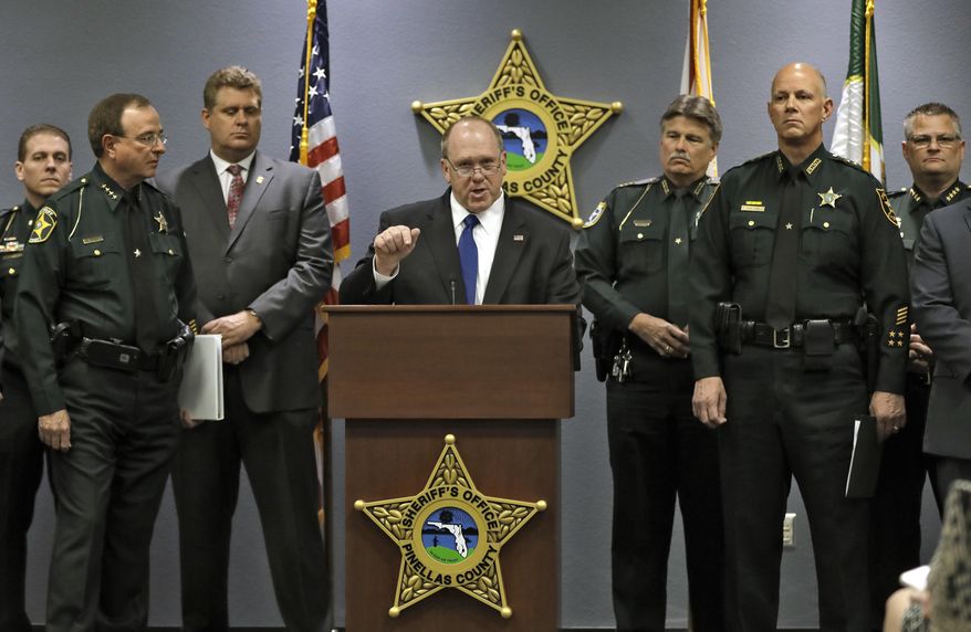 U.S. Immigration and Customs Enforcement Deputy Director Thomas Homan, center, gestures as he is surrounded by several Florida sheriffs during a news conference Wednesday, Jan. 17, 2018, in Largo, Fla. U.S. Immigration and Customs Enforcement officials joined the sheriffs to announce new efforts to enhance public safety. (AP Photo/Chris O'Meara)