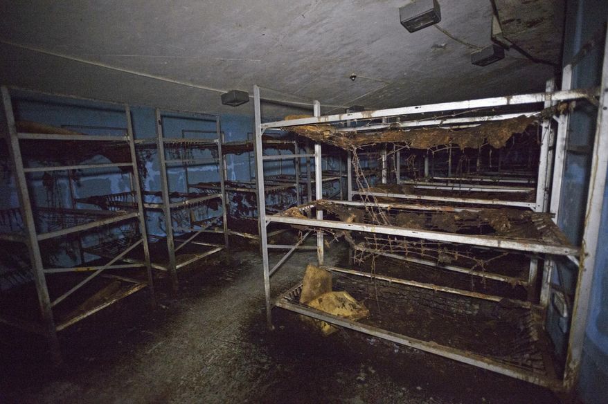 In this Tuesday, Sept. 26, 2017 photo, a bay of bunkbeds can be seen in a crescent shaped room inside a Cold War era Civil Defense bunker in New Orleans. A generation of Americans knew just what to do in the event of a nuclear attack - or during a major false alarm, like the one over the weekend in Hawaii. Take cover in a building bearing a yellow fallout shelter symbol. But these days, that might not be the best option, or even an option at all. (Max Becherer /The Advocate via AP)