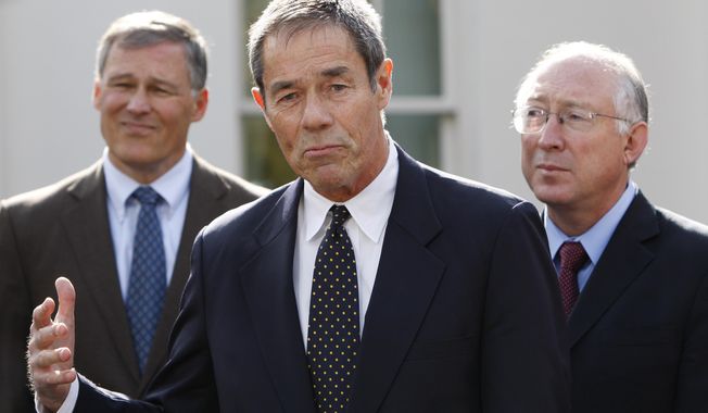 FILE - In this Nov. 2, 2009 file photo, former Alaska Gov. Tony Knowles, center, accompanied by Rep. Jay Inslee, D-Wash., left, and Interior Secretary Ken Salazar, gestures while speaking to members of the media following their meeting at the White House in Washington. A U.S. Interior Department official has reacted harshly to the resignation of most members of a board that advises it on national parks. Knowles chaired the congressionally authorized board until Tuesday, Jan. 16, 2018, the Democrat and eight others on the 12-member board sent a resignation letter, saying their requests to meet as prescribed in law have been disregarded. (AP Photo/Pablo Martinez Monsivais,File)
