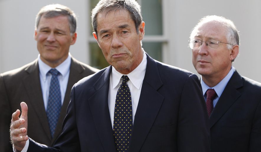 FILE - In this Nov. 2, 2009 file photo, former Alaska Gov. Tony Knowles, center, accompanied by Rep. Jay Inslee, D-Wash., left, and Interior Secretary Ken Salazar, gestures while speaking to members of the media following their meeting at the White House in Washington. A U.S. Interior Department official has reacted harshly to the resignation of most members of a board that advises it on national parks. Knowles chaired the congressionally authorized board until Tuesday, Jan. 16, 2018, the Democrat and eight others on the 12-member board sent a resignation letter, saying their requests to meet as prescribed in law have been disregarded. (AP Photo/Pablo Martinez Monsivais,File)