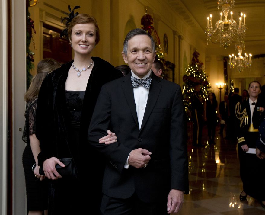 FILE - In this Dec. 8, 2013 file photo, former Rep. Dennis Kucinich, D-Ohio, and his wife Elizabeth Kucinich, arrive for a reception honoring the 2013 Kennedy Center Honors honorees, in the East Room of the White House in Washington. Kucinich is preparing to make the Democratic primary for Ohio governor a five-way race. The outspoken Democrat is set to make his announcement on Wednesday, Jan. 17, 2018, at a community center in Middleburg Heights, Ohio. (AP Photo/Manuel Balce Ceneta, File)