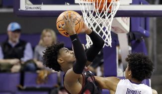 Stanford&#39;s Daejon Davis, left, grabs a rebound in front of Washington&#39;s Matisse Thybulle in the second half of an NCAA college basketball game Saturday, Jan. 13, 2018, in Seattle. (AP Photo/Elaine Thompson)