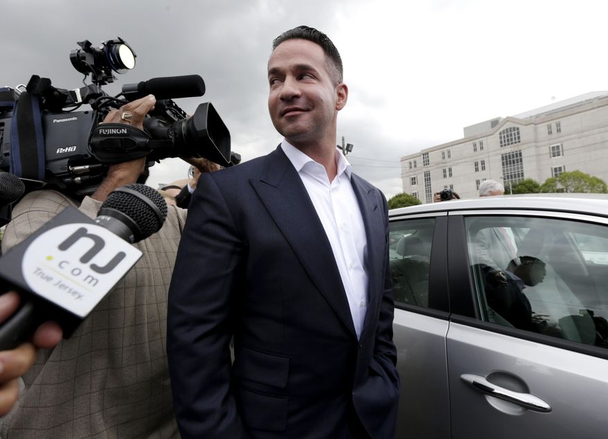 FILE - In this Sept. 24, 2014, file photo, reporters gather around Mike "The Situation" Sorrentino as he leaves the MLK Jr. Federal Courthouse in Newark, N.J., after a court appearance. Former “Jersey Shore” reality TV star Sorrentino is expected to plead guilty to federal tax charges. A letter filed with the court on Wednesday, Jan. 17, 2018, said Sorrentino and his brother, Marc, plan to plead guilty at a court hearing on Friday in Newark. The pair was charged in 2014 with filing bogus tax returns on nearly $9 million in income. Additional charges were filed last April. (AP Photo/Julio Cortez, File)