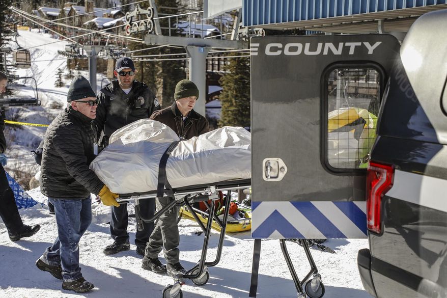 Officials put the body of man found in Gore Creek into the Coroner's truck on Tuesday, Jan. 16, in Lionshead in Vail, Colo. The incident is still being investigated. (Chris Dillmann/Vail Daily via AP)